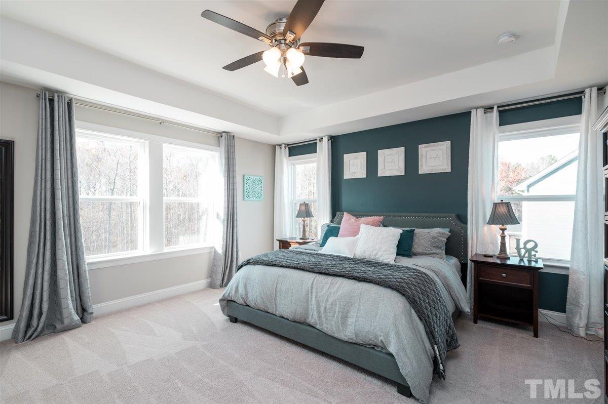 7056 Rex Road Holly Springs, NC 27540 - Photo 5 of 28 Luxurious owner's suite with tray ceilings, designer wall colors and lots of natural light