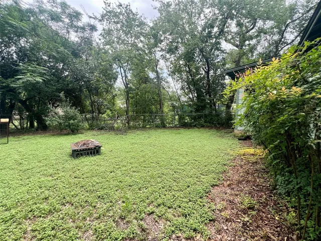 a green field with lots of trees