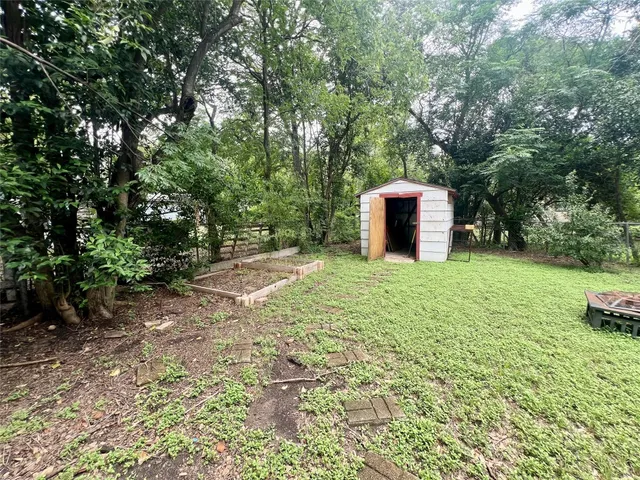 a view of a backyard with large trees