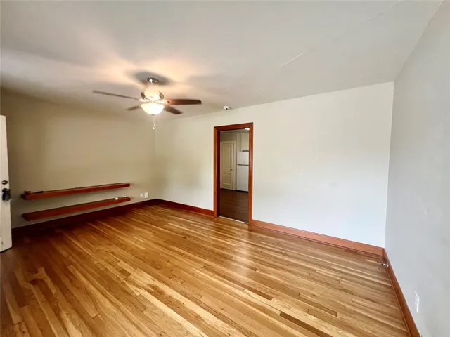 a view of a room with wooden floor and fan