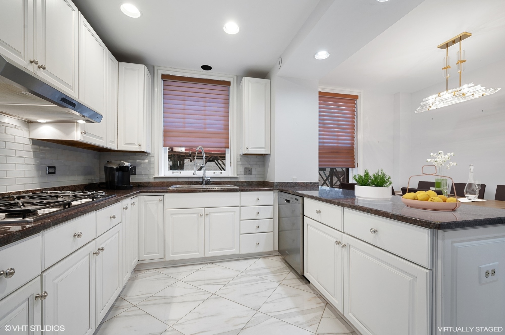 237 East Delaware Place, Unit 2A Chicago, IL 60611 - Photo 4 of 19 a kitchen with stainless steel appliances granite countertop a sink and white cabinets