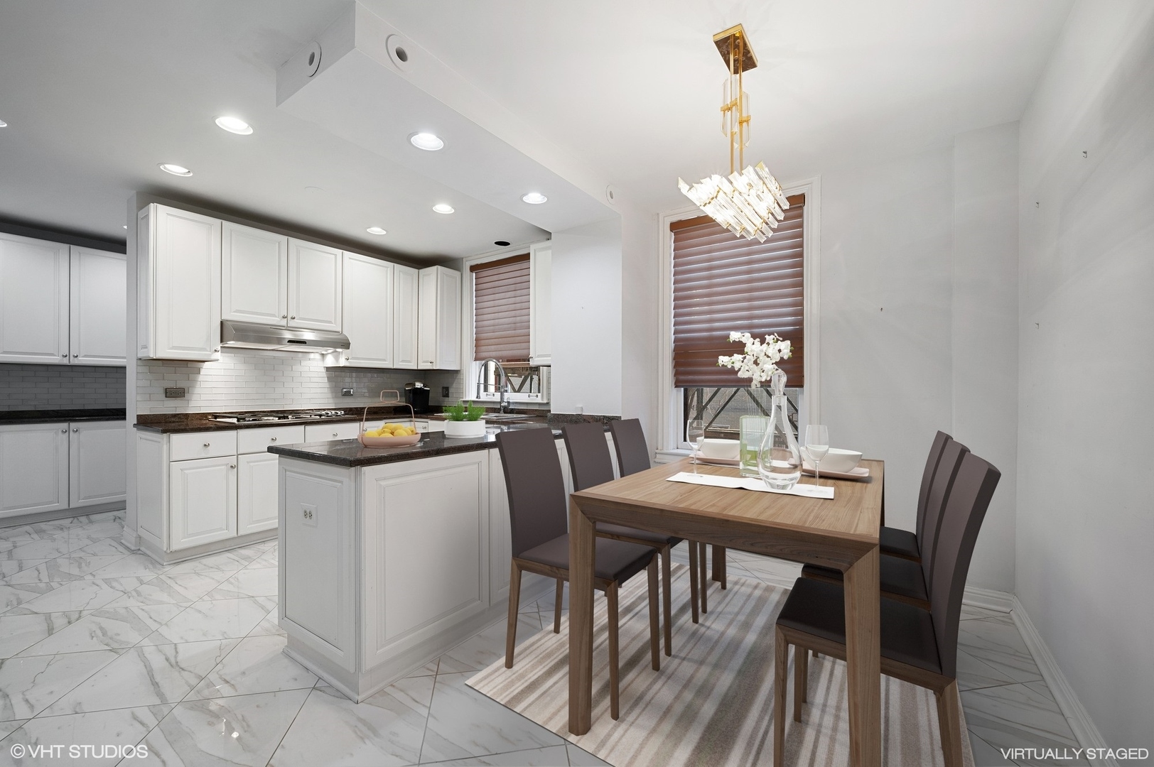 237 East Delaware Place, Unit 2A Chicago, IL 60611 - Photo 5 of 19 a kitchen with kitchen island granite countertop white cabinets and stainless steel appliances