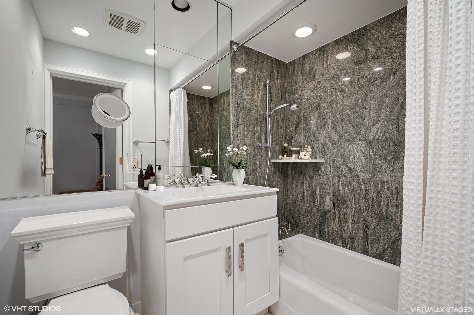 237 East Delaware Place, Unit 2A Chicago, IL 60611 - Photo 10 of 19 a bathroom with a sink a toilet a mirror and shower