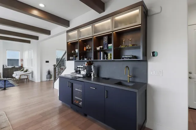 a bedroom with a bed and large windows