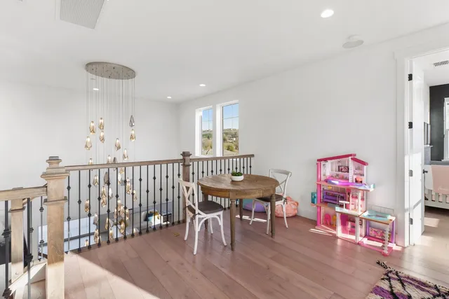 a view of a patio with couches and table and chairs and potted plants