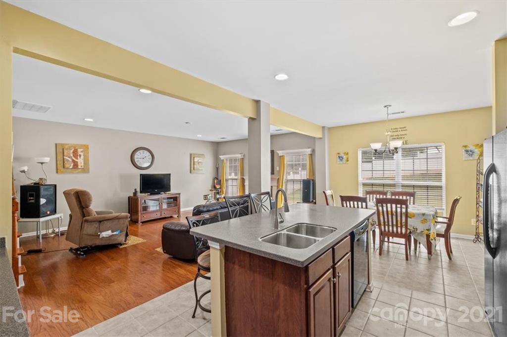 9528 Gilead Grove Road Huntersville, NC 28078 - Photo 14 of 38 a open kitchen with stainless steel appliances granite countertop a table and chairs in it
