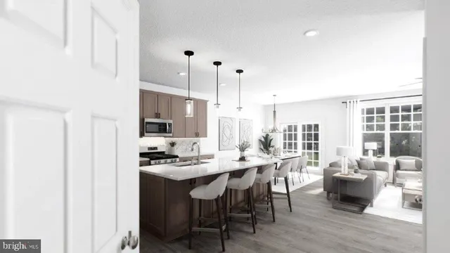 a dining hall with stainless steel appliances kitchen island granite countertop a sink table and chairs