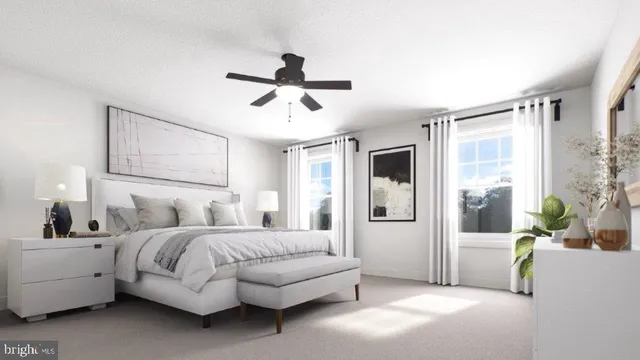 a spacious bedroom with a bed a couch and a window