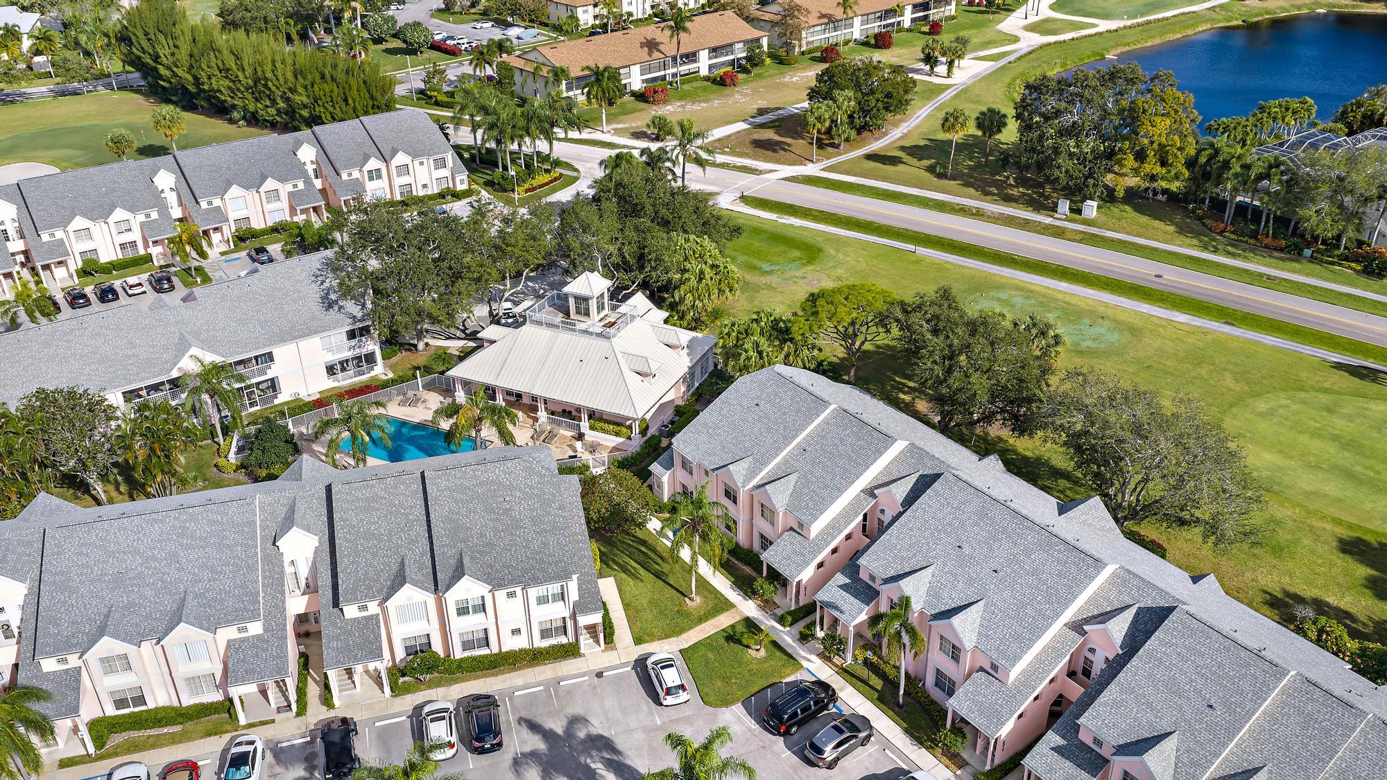 an aerial view of a house with a garden and lake view