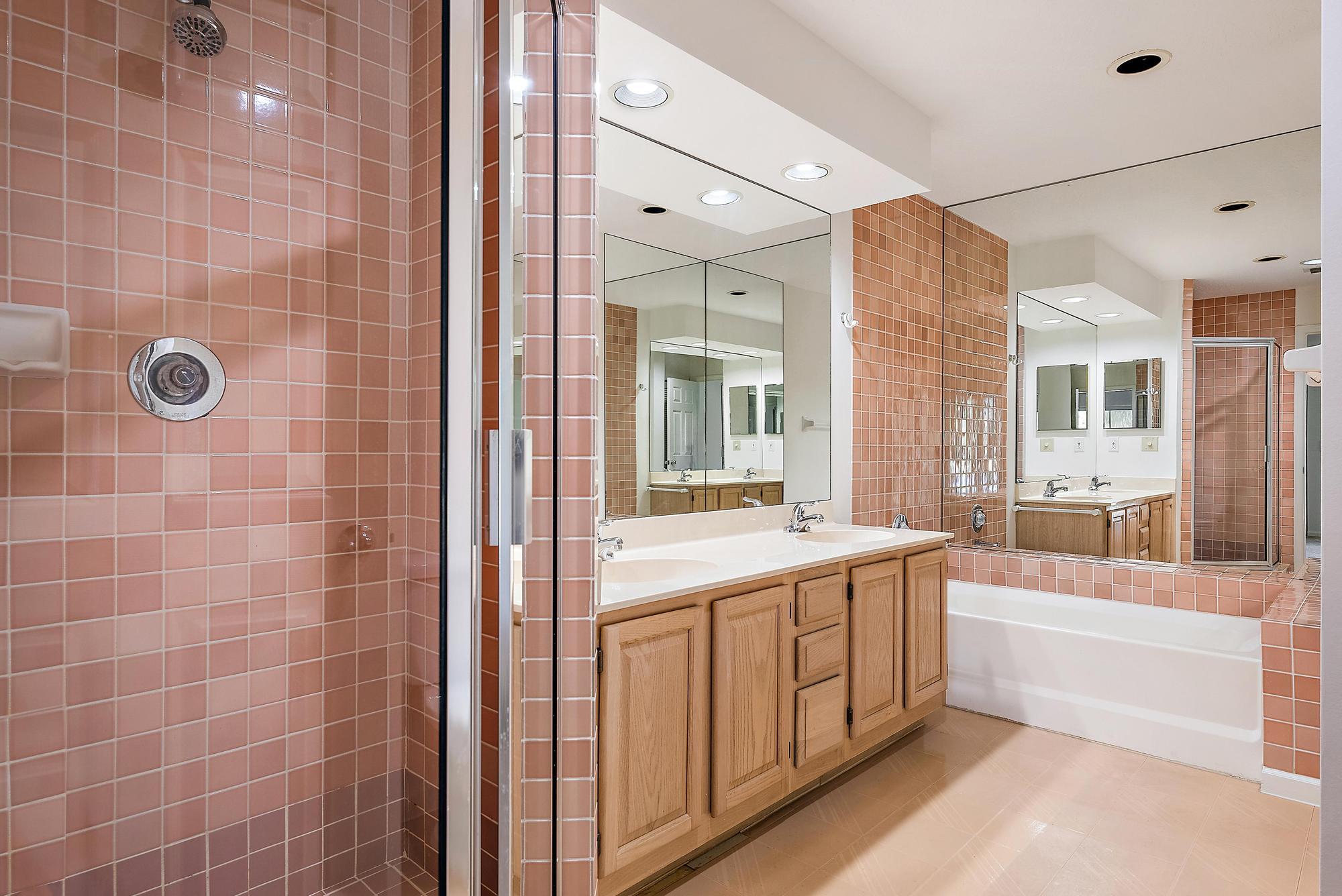 802 Muirfield Court, Unit 802A Jupiter, FL 33458 - Photo 13 of 25 a bathroom with a tub a sink and a large mirror