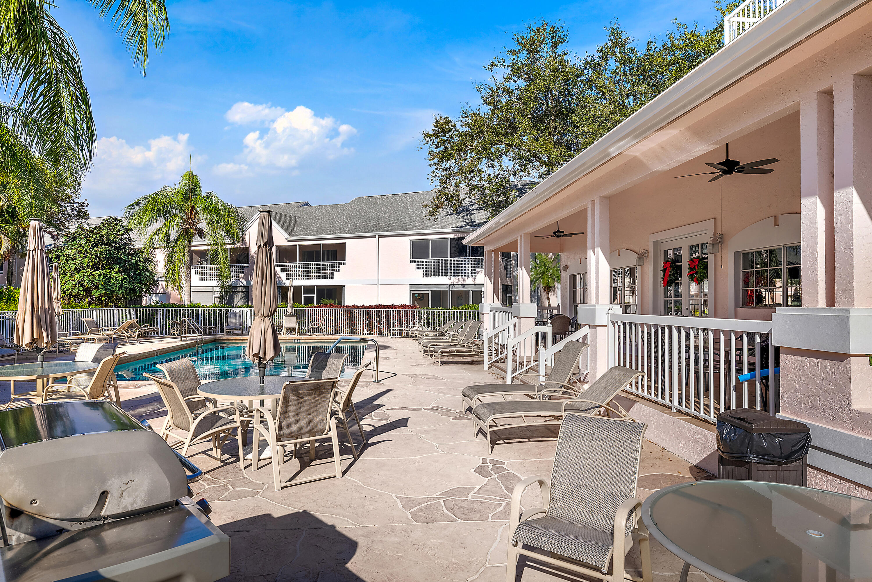 802 Muirfield Court, Unit 802A Jupiter, FL 33458 - Photo 17 of 25 a view of a patio with couches table and chairs and potted plants