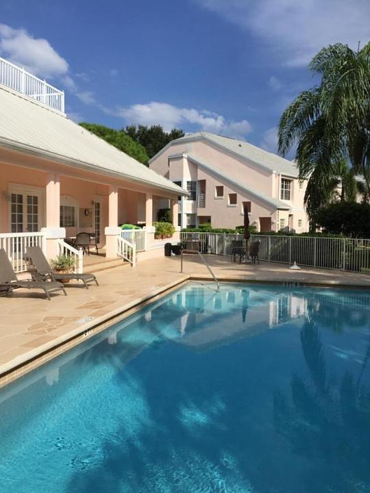 802 Muirfield Court, Unit 802A Jupiter, FL 33458 - Photo 3 of 25 a swimming pool view with a outdoor seating