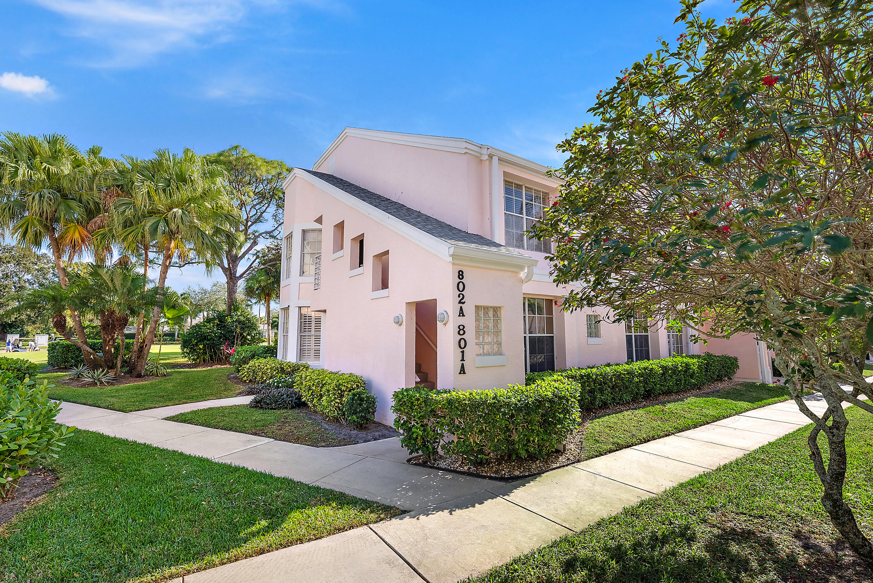 802 Muirfield Court, Unit 802A Jupiter, FL 33458 - Photo 4 of 25 a front view of a house with a yard
