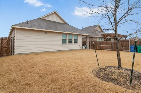 a house that has a tree in front of it