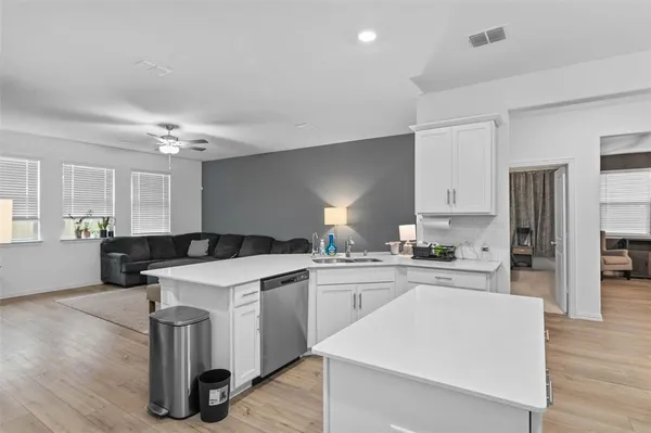 a kitchen with a stove a sink and a refrigerator