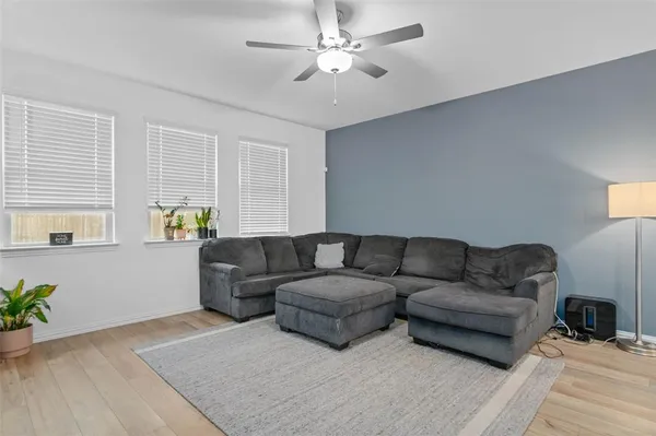 a living room with furniture and a wooden floor