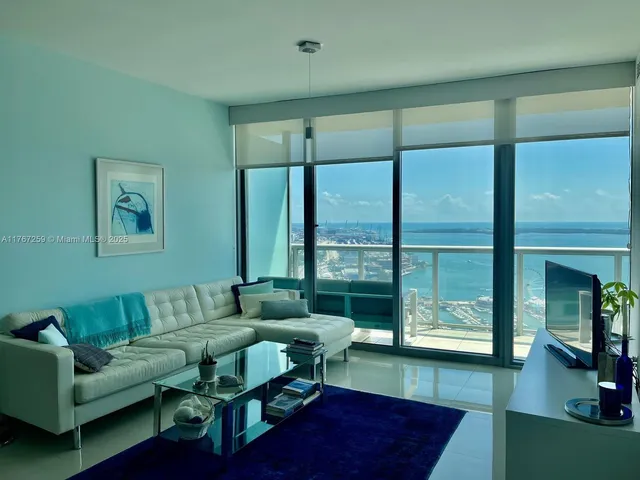 a living room with furniture and a piano