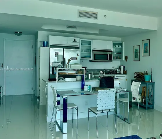 a bedroom with a bed a large window and a book shelf