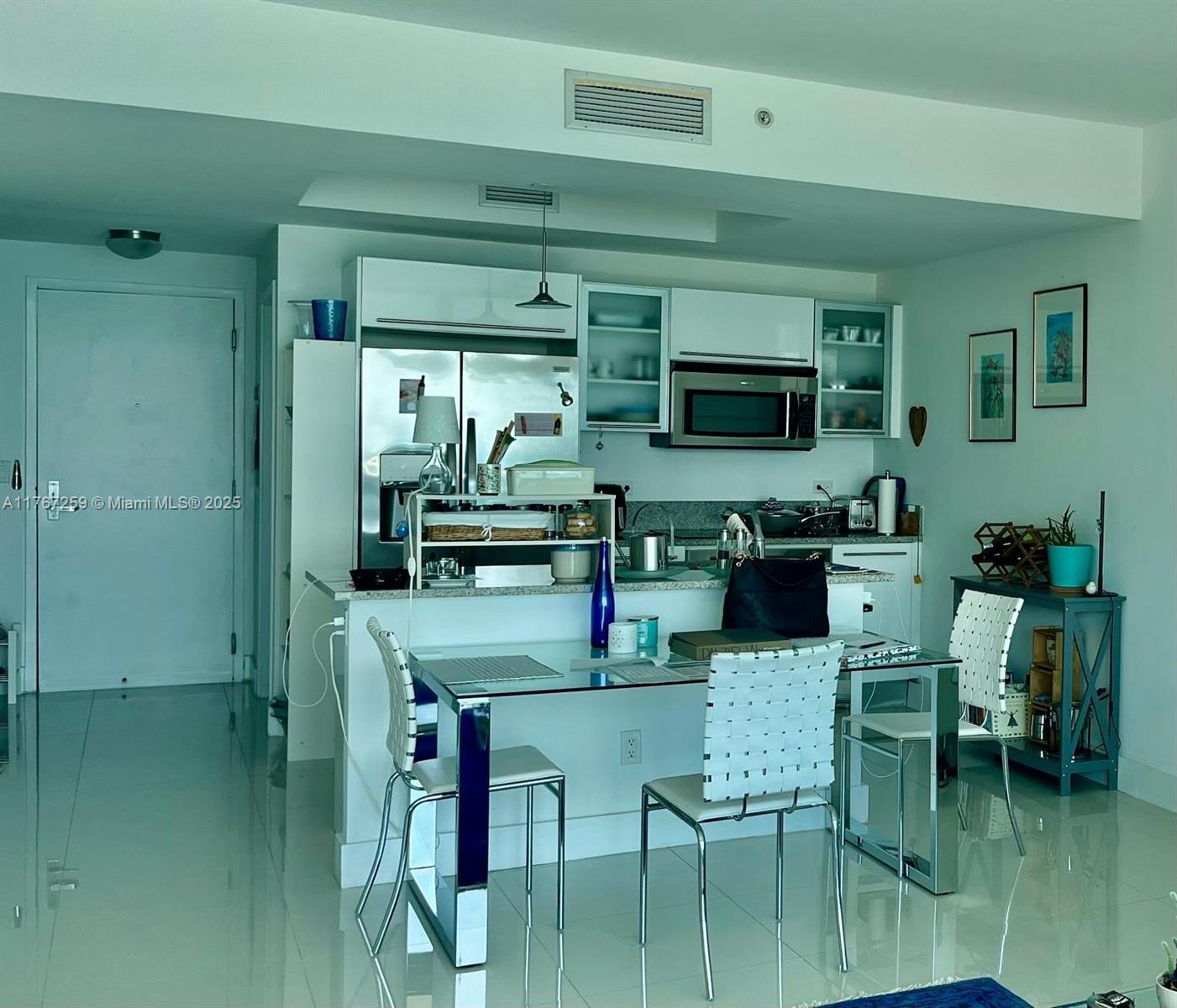 888 Biscayne Boulevard, Unit 4306 Miami, FL 33132 - Photo 22 of 70 a kitchen with stainless steel appliances kitchen island granite countertop a table and chairs
