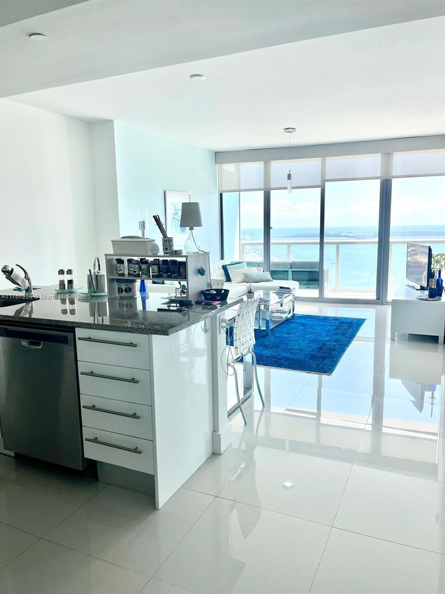 888 Biscayne Boulevard, Unit 4306 Miami, FL 33132 - Photo 25 of 70 a room with a table chairs and a view of living room