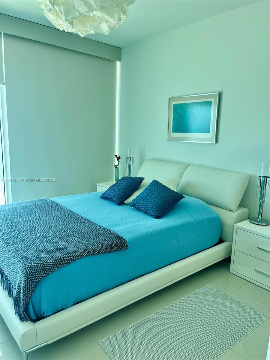 888 Biscayne Boulevard, Unit 4306 Miami, FL 33132 - Photo 30 of 70 a bedroom with a bed and a window