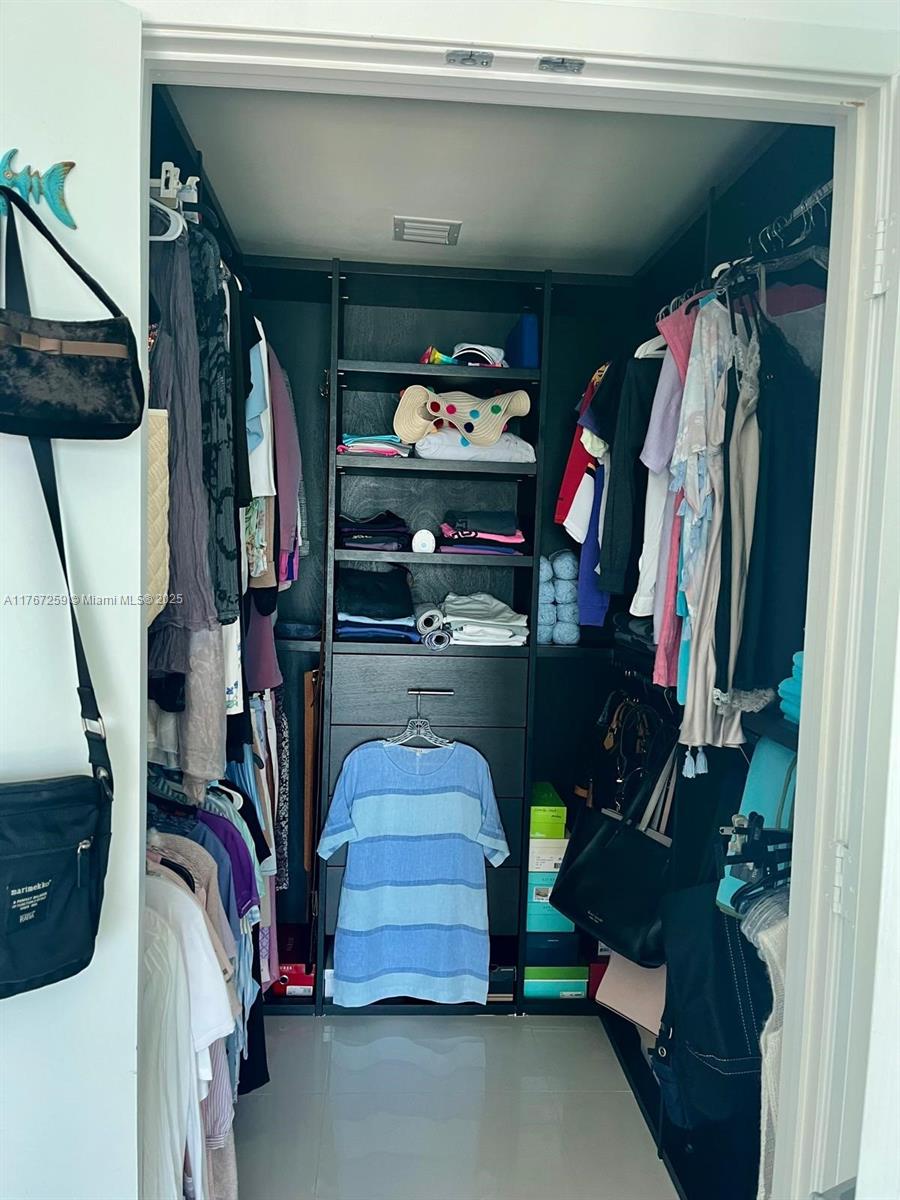 888 Biscayne Boulevard, Unit 4306 Miami, FL 33132 - Photo 31 of 70 a view of walk in closet with clothes and shoes