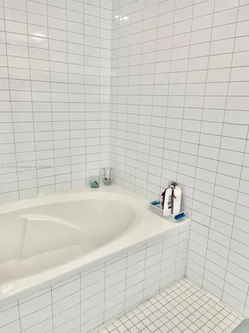 a bathroom with a sink mirror and toilet