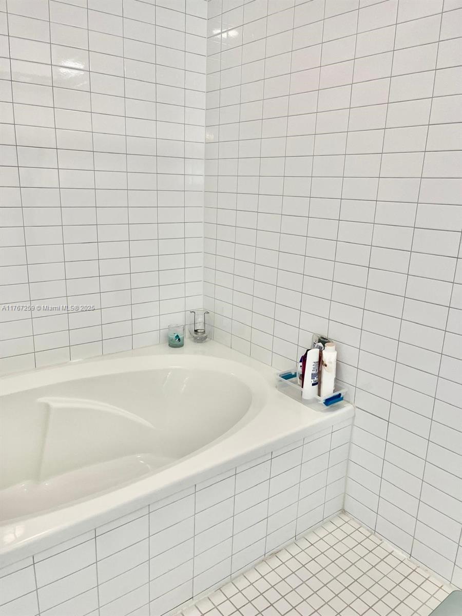 888 Biscayne Boulevard, Unit 4306 Miami, FL 33132 - Photo 35 of 70 a bathroom with a bathtub and shower