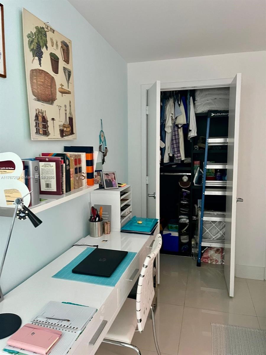 888 Biscayne Boulevard, Unit 4306 Miami, FL 33132 - Photo 40 of 70 a bedroom with a bed and cabinets