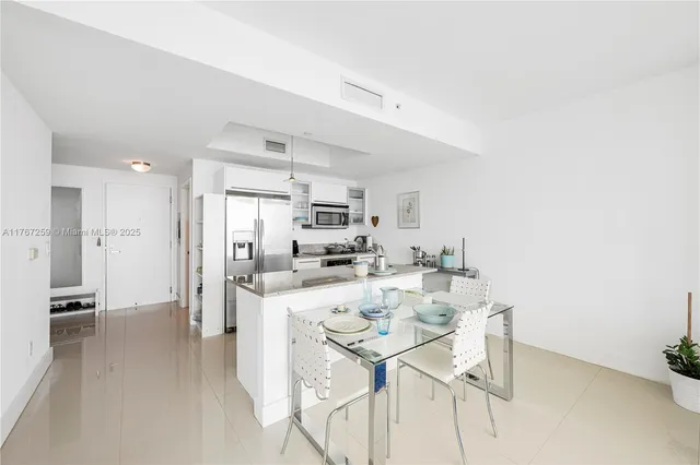 a bedroom with a bed furniture and a large window