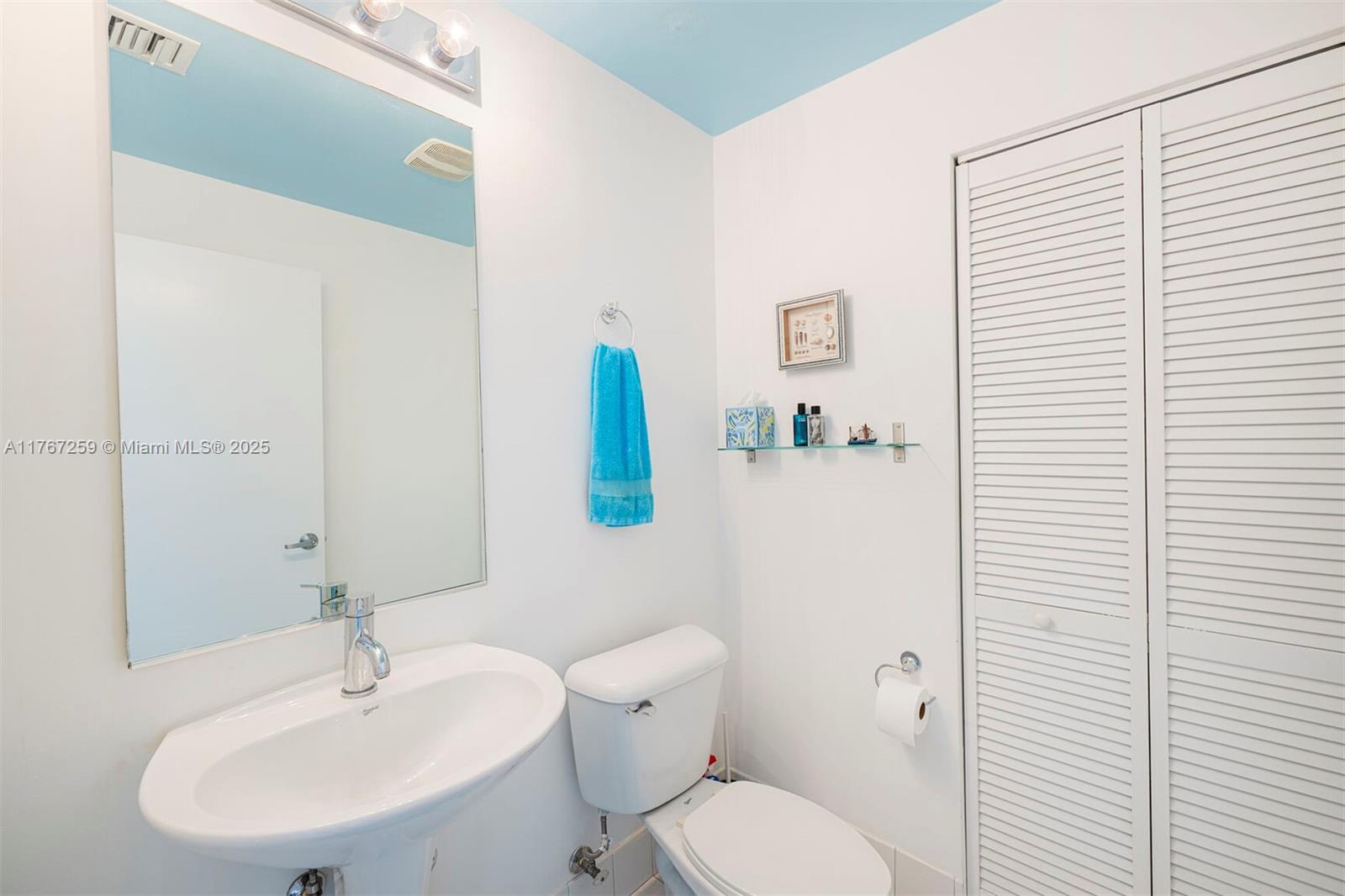 888 Biscayne Boulevard, Unit 4306 Miami, FL 33132 - Photo 41 of 70 a white toilet sitting next to a bathroom sink