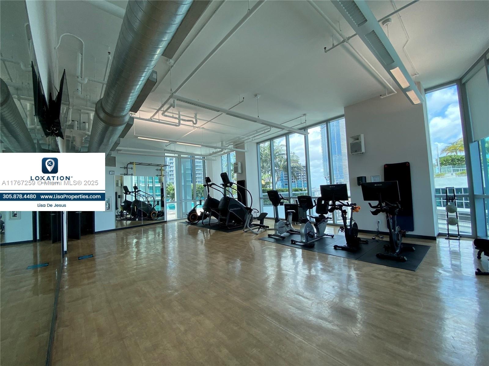 888 Biscayne Boulevard, Unit 4306 Miami, FL 33132 - Photo 54 of 70 a living room with fireplace furniture and a flat screen tv