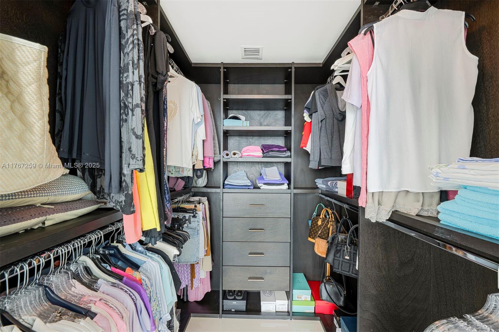 888 Biscayne Boulevard, Unit 4306 Miami, FL 33132 - Photo 8 of 70 a view of walk in closet with clothes and shoes