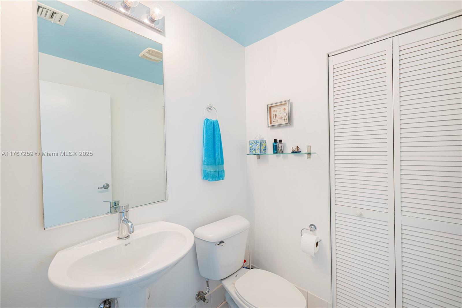 888 Biscayne Boulevard, Unit 4306 Miami, FL 33132 - Photo 10 of 70 a white toilet sitting next to a bathroom sink