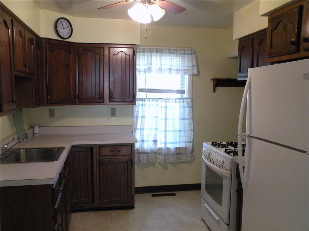 119 Upper Arrowhead Road Pittsburgh, PA 15237 - Photo 6 of 10 a kitchen with a refrigerator and a sink