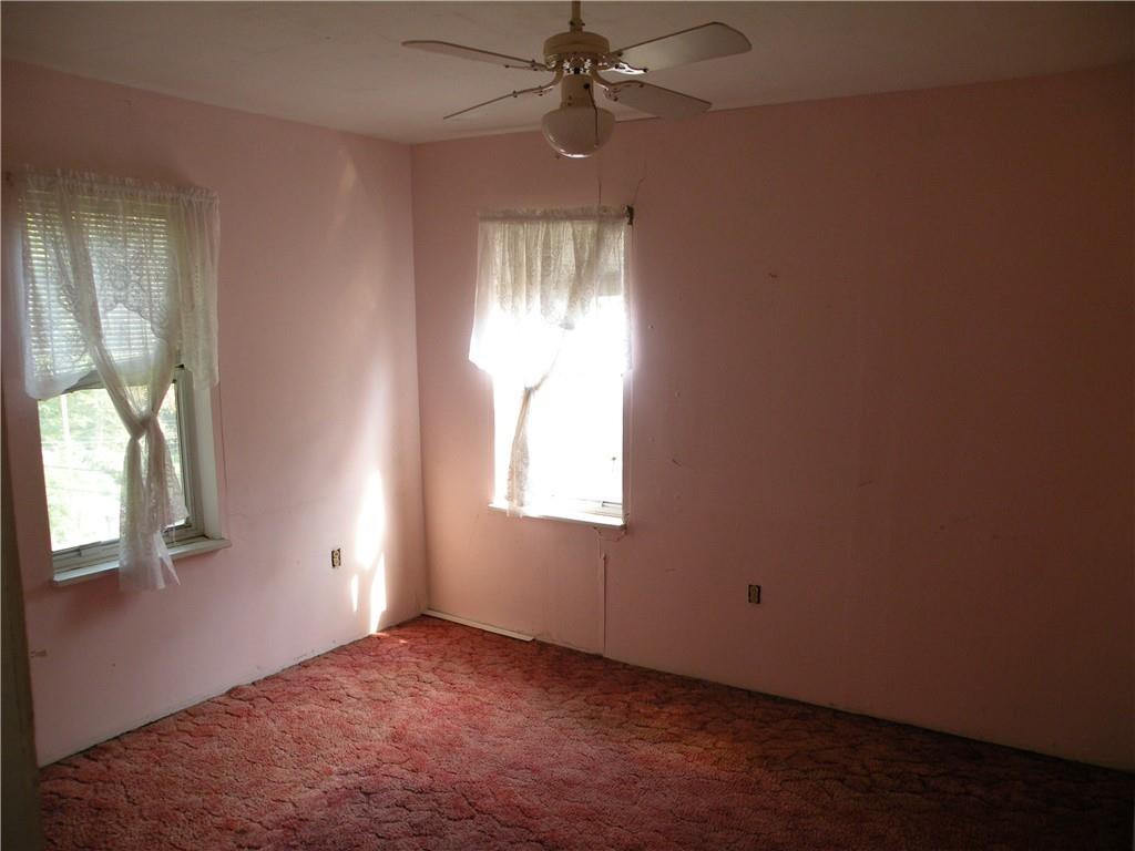 119 Upper Arrowhead Road Pittsburgh, PA 15237 - Photo 9 of 10 an empty room with windows and chandelier fan