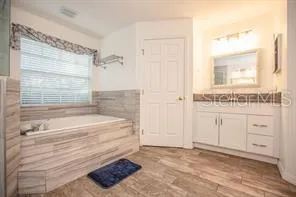 a bathroom with a bathtub and a sink