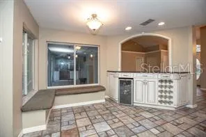 a view of a hallway with entryway and chandelier