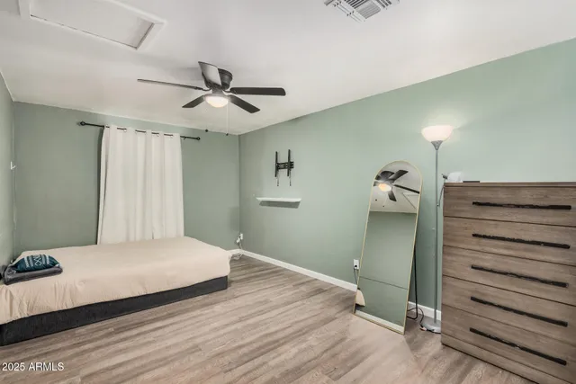 a bedroom with a bed and a ceiling fan