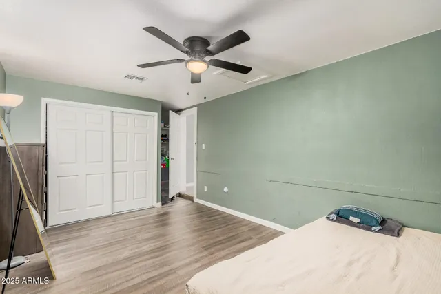 a bedroom with a large bed and a chandelier