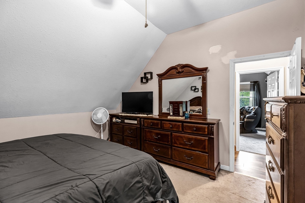 302 Middlefield Road Chester, MA 01011 - Photo 24 of 42 a bedroom with a bed and a flat tv screen on the dresser