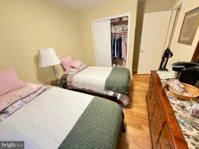 a bedroom with two beds and a lamp