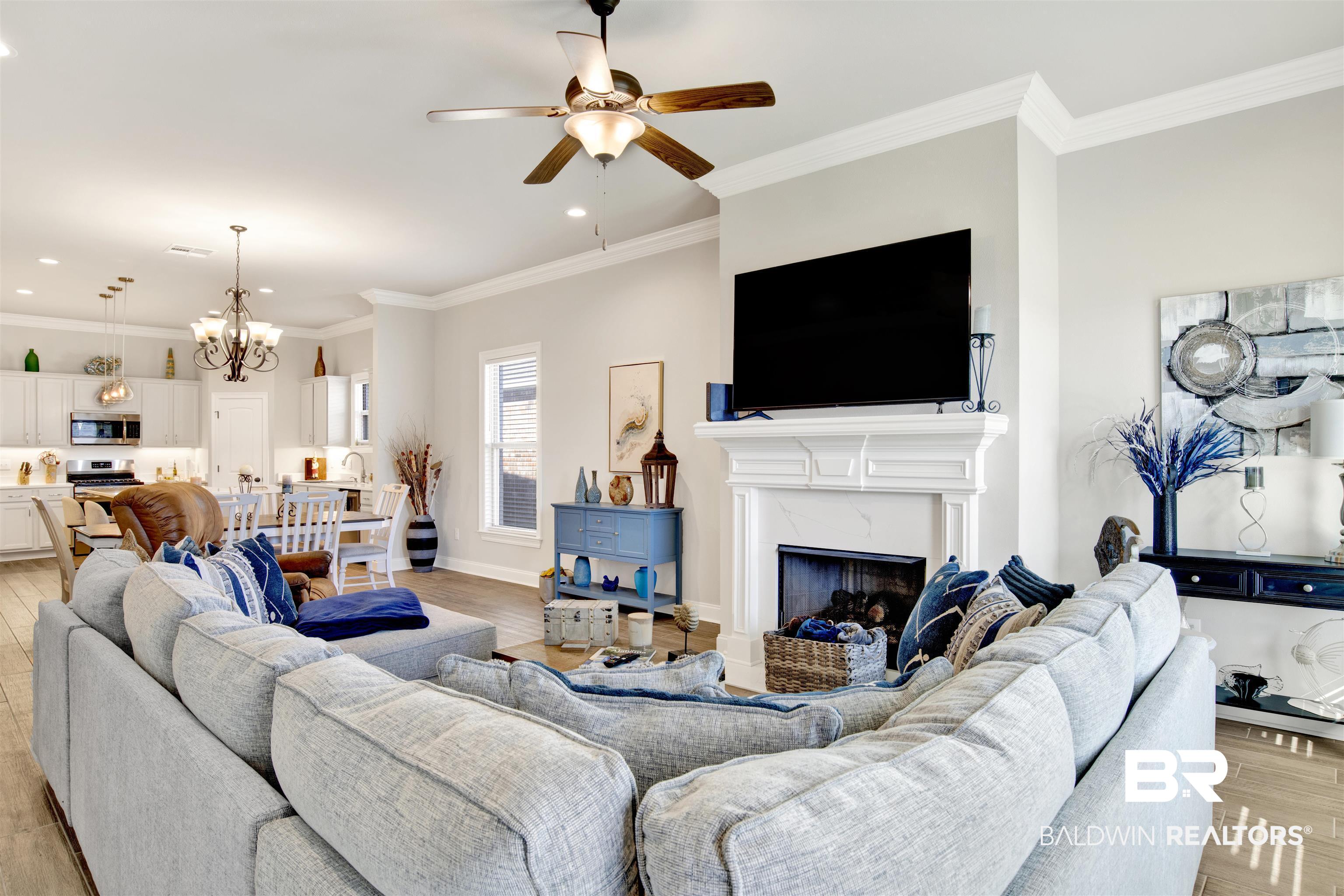 1406 Aldon Street Foley, AL 36535 - Photo 6 of 30 Living room with a high-end fireplace, luxury wood-look tile flooring, and ornamental molding
