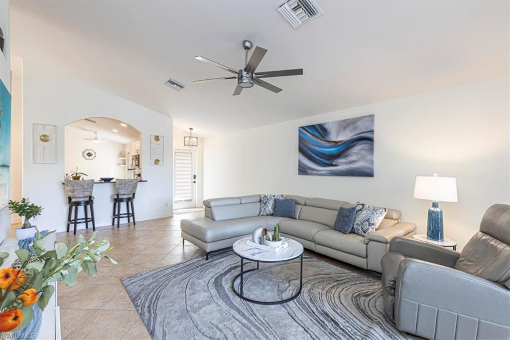 1630 Triangle Palm Terrace Naples, FL 34119 - Photo 5 of 24 a living room with furniture and wooden floor