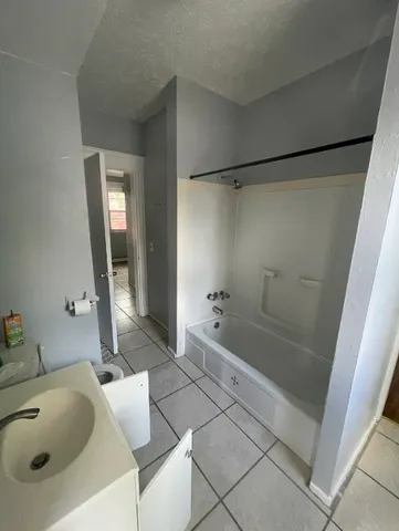 a bathroom with a bathtub and a sink