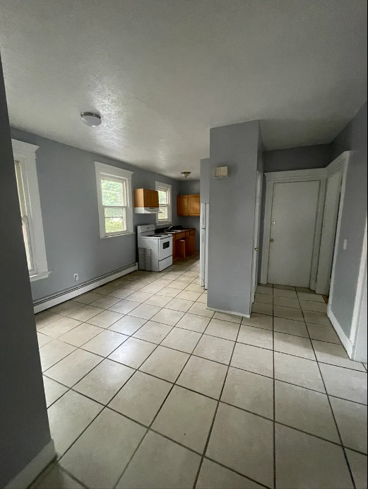 414 Dixwell Avenue, Unit 2 New Haven, CT 06511 - Photo 4 of 8 a view of empty room with windows and cabinet