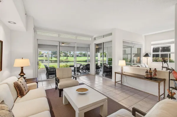 a view of a dining room kitchen and livingroom with furniture wooden floor and a rug