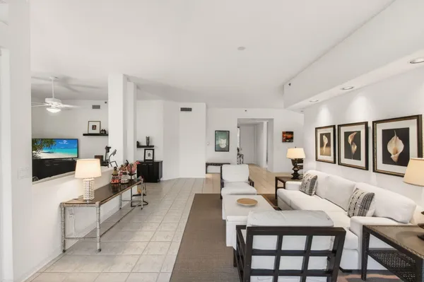 a living room with furniture and a chandelier