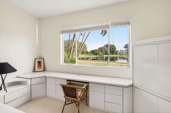 a bedroom with a bed and a flat tv screen on dresser