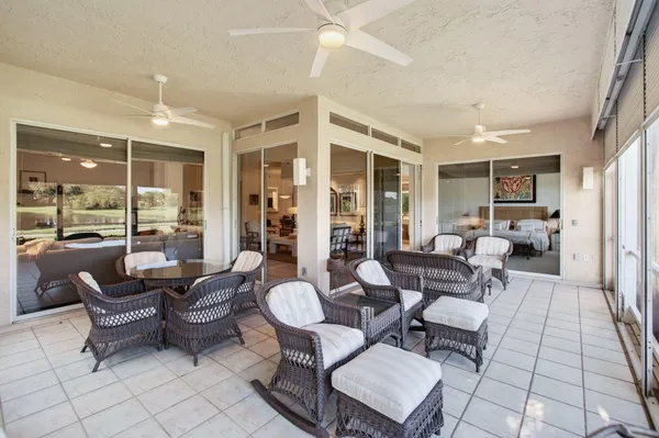 a dining room with furniture a flat screen tv and a large window